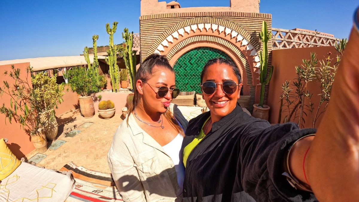 LGBTQ cute lesbian gay selfie in hotel riad in Marrakech Morocco, girl with braids, summer