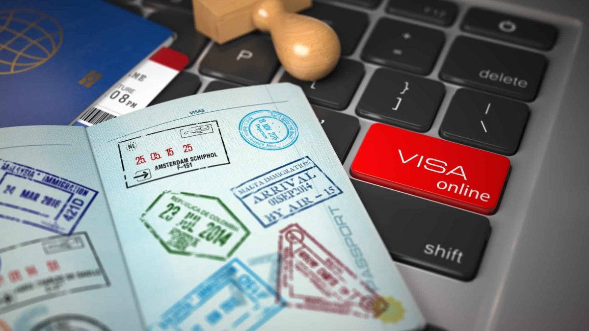 Visa online application concept. Open passport with visa stamps